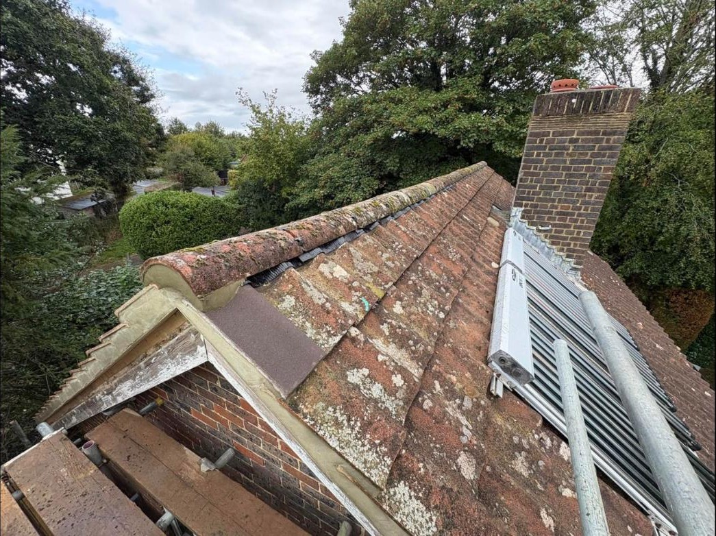 Completed roof ridge with re-bedded tiles and dry ridge system, Forest Row