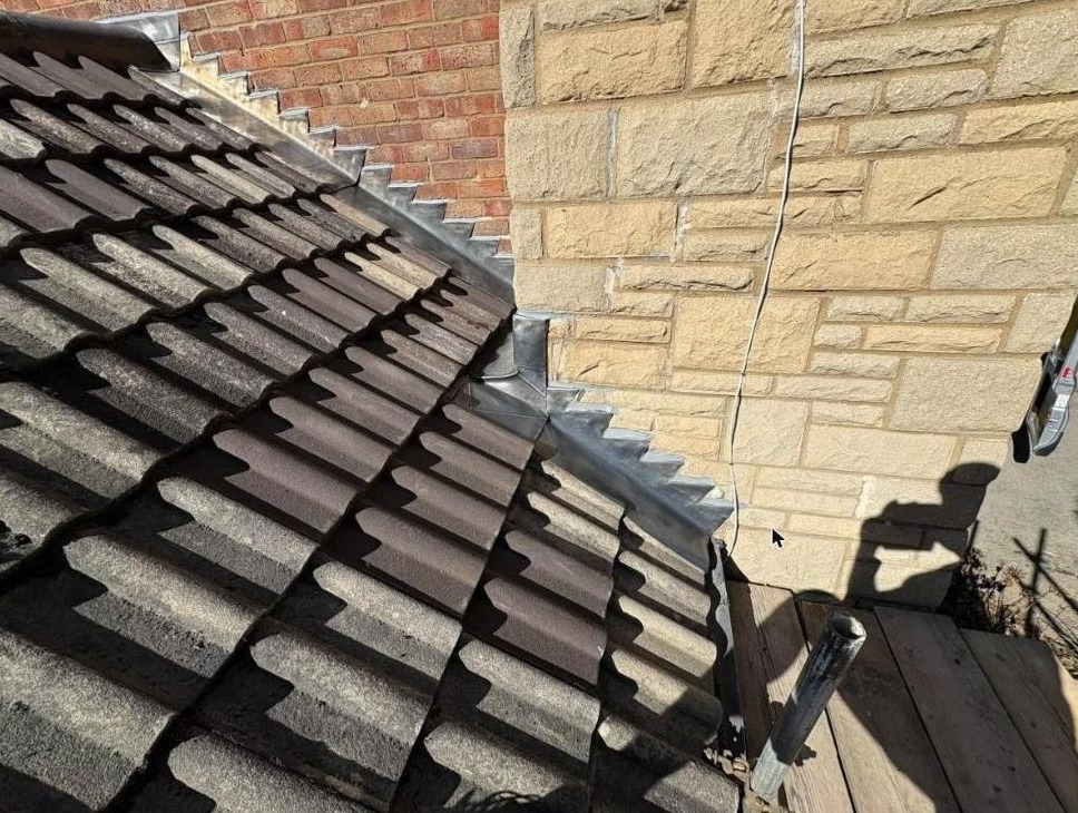 New code 4 lead flashing wrapped around a stone chimney stack, Oxted